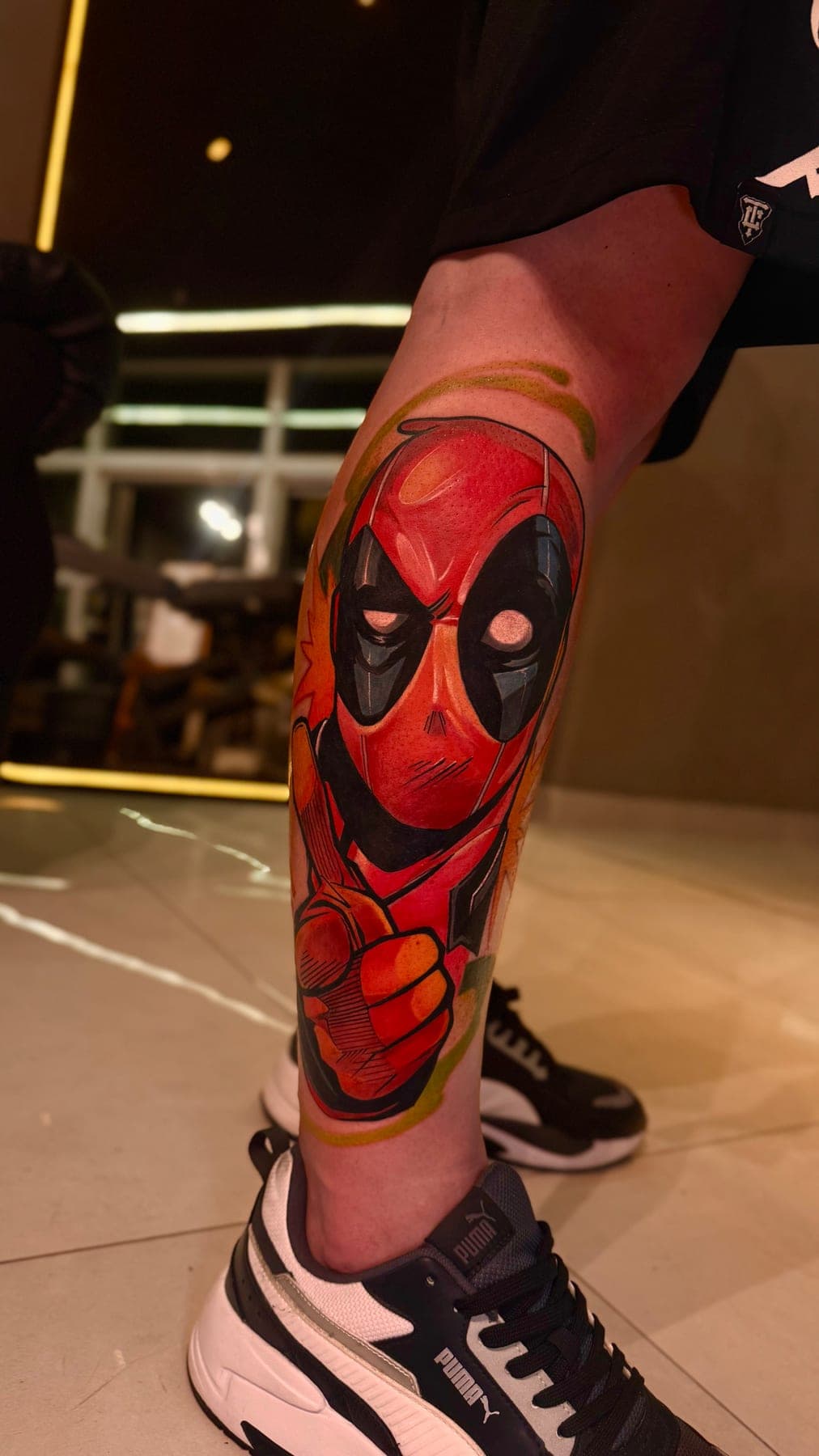 Panturrilha em cor: personagem mascarado de vermelho com o punho fechado, sobre chamas laranja